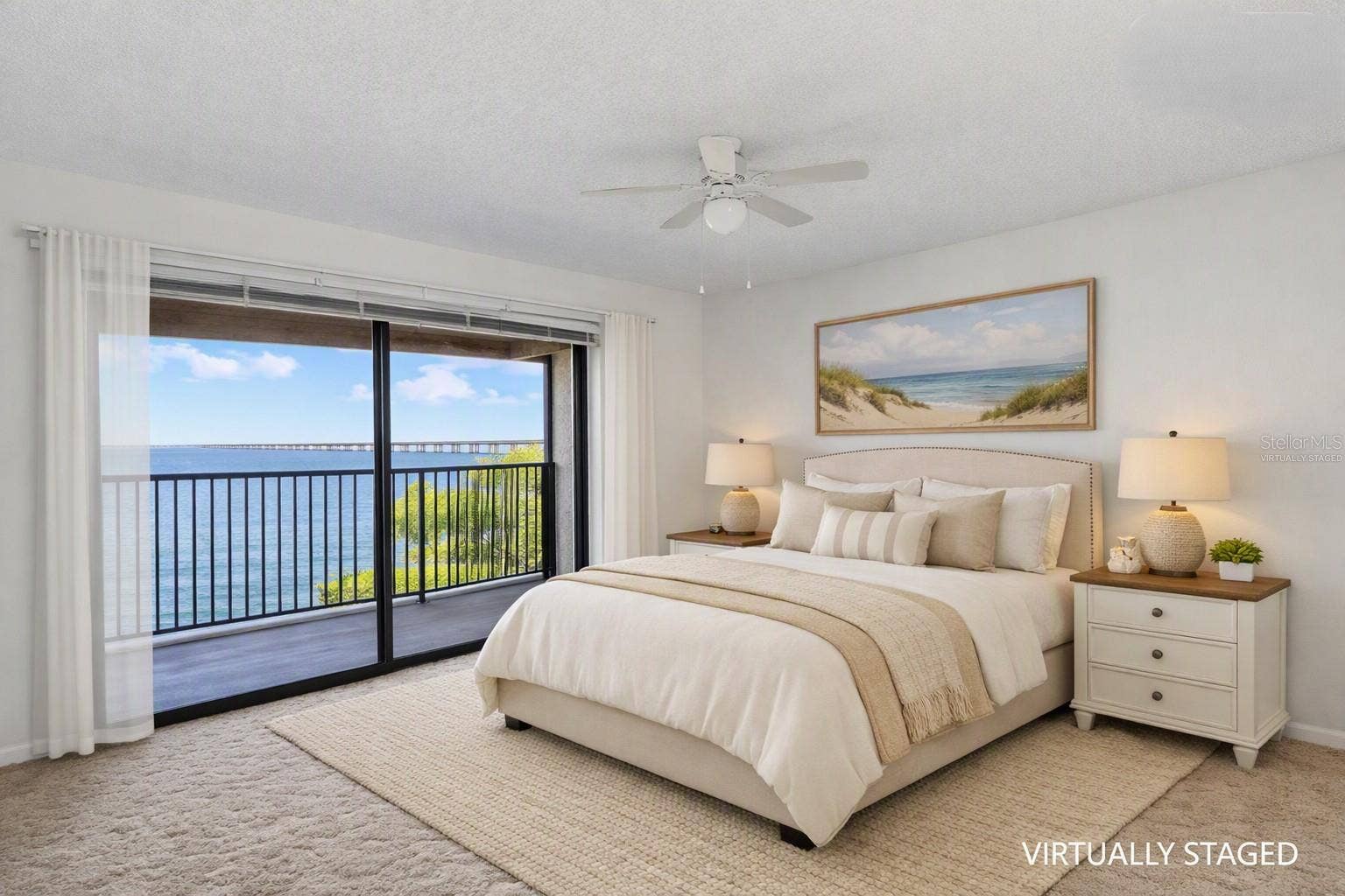 2980 HAINES BAYSHORE ROAD, #105, Clearwater, FL 33760 Virtually staged - primary bedroom over looking the balcony with full panoramic water views