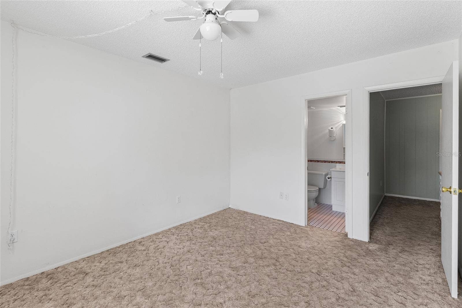 2980 HAINES BAYSHORE ROAD, #105, Clearwater, FL 33760 Secondary bedroom looking toward ensuite bath and door