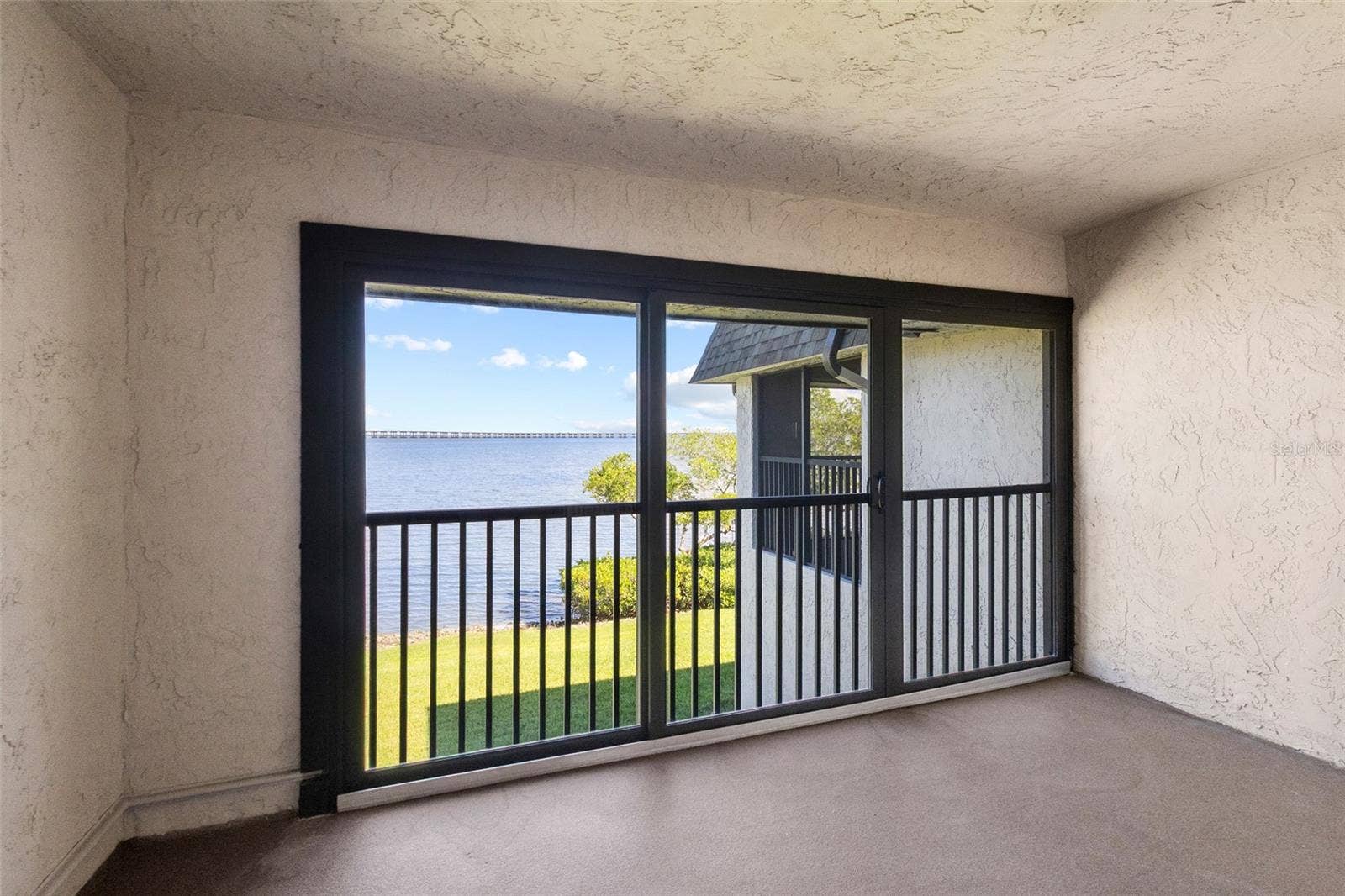 2980 HAINES BAYSHORE ROAD, #105, Clearwater, FL 33760 Balcony off primary bedroom - full panoramic water views