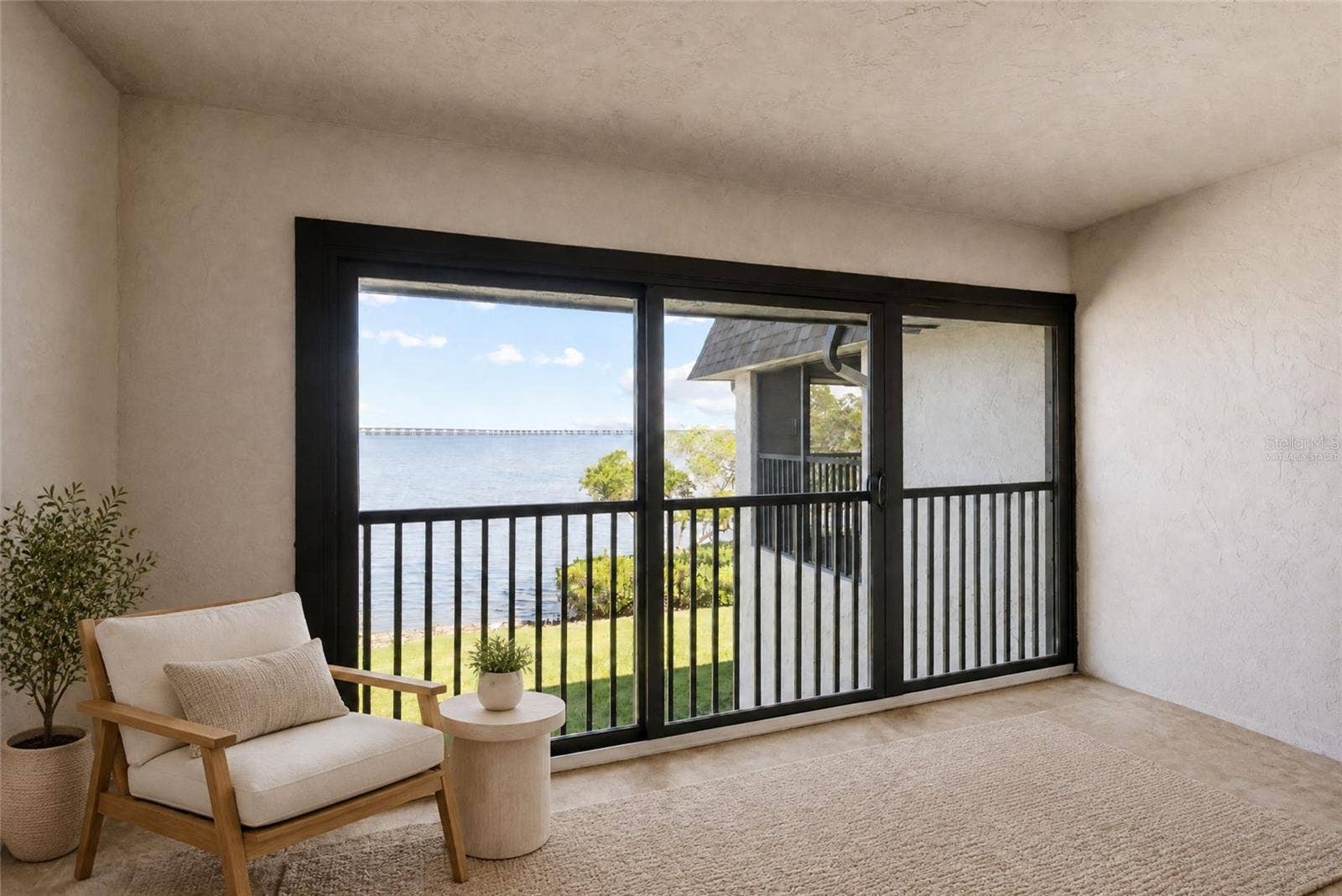 2980 HAINES BAYSHORE ROAD, #105, Clearwater, FL 33760 Virtually staged balcony off primary bedroom with panoramic water views