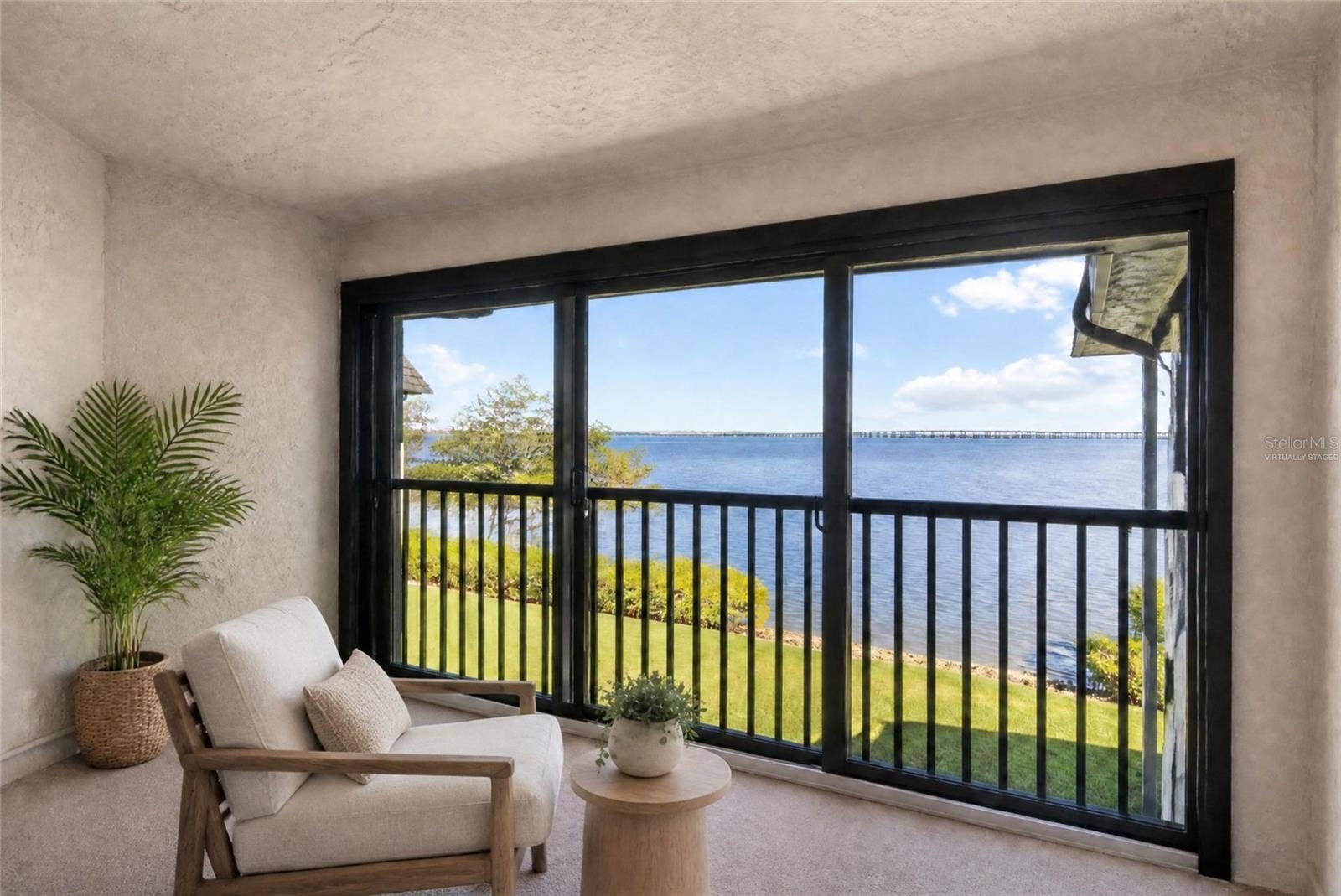 2980 HAINES BAYSHORE ROAD, #105, Clearwater, FL 33760 Virtually staged - primary bedroom balcony with water view