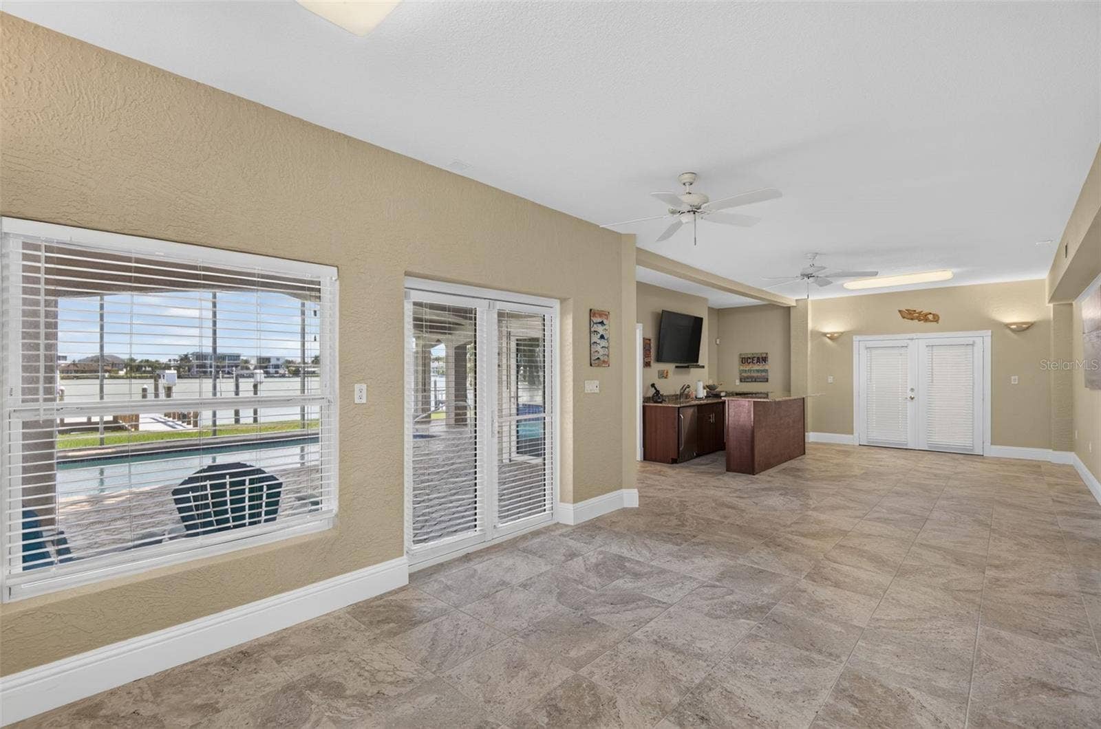 17021 DOLPHIN DRIVE, North Redington Beach, FL 33708 BONUS AREA DOWNSTAIRS BETWEEN GARAGES DOORS TO WEST GARAGE & POOL PATIO