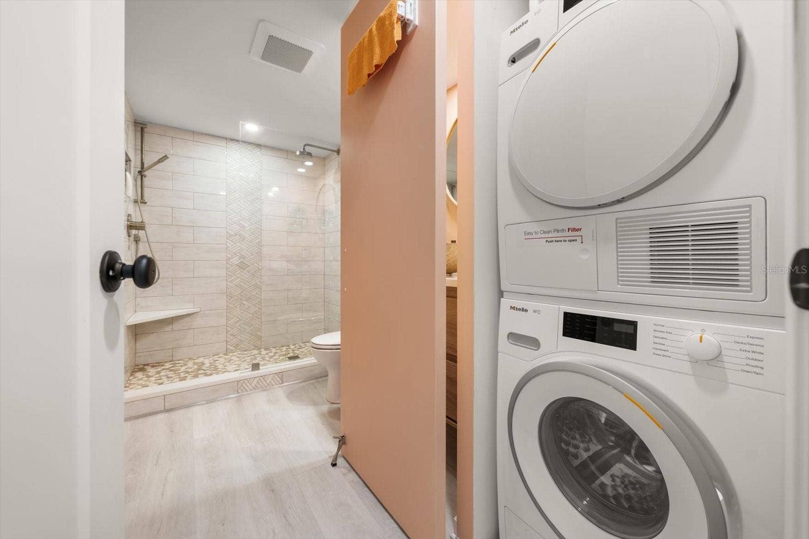 In unit Miele washing machine & dryer; discreetly tucked away in the guest bath.