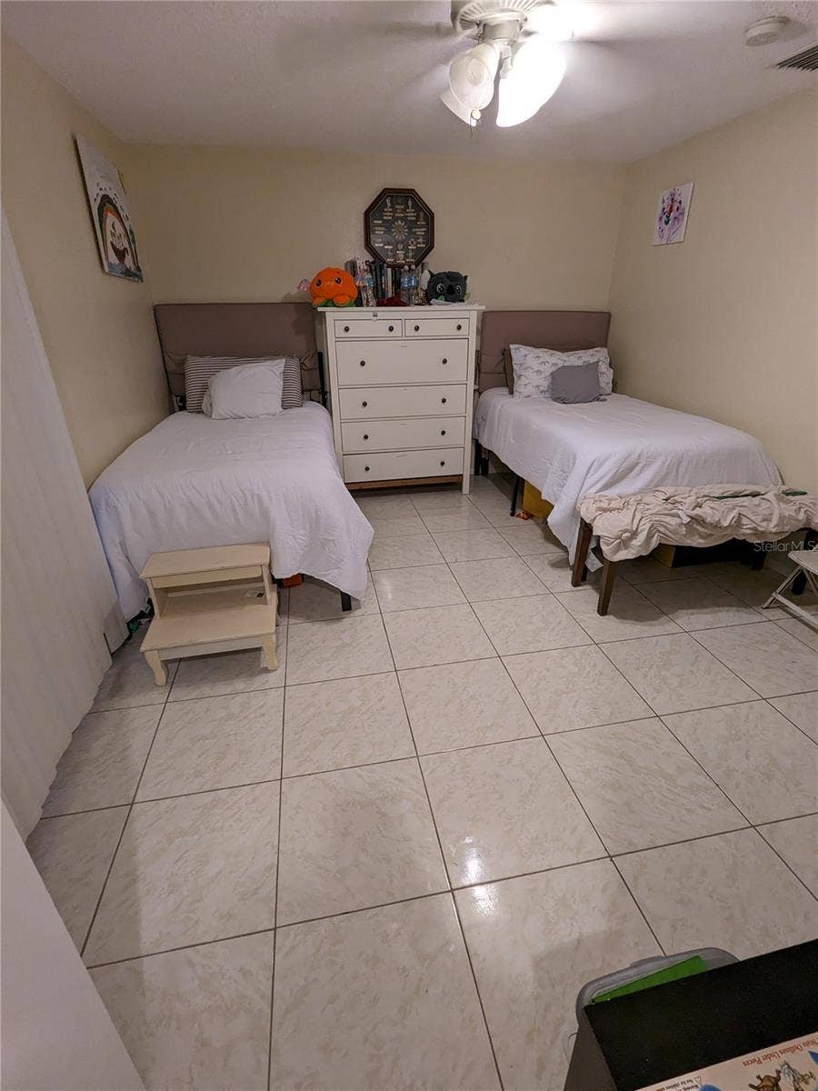 3937 SAIL DRIVE, New Port Richey, FL 34652 GUEST BEDROOM AT FRONT OF HOUSE HAS LONG WINDOWS & WALK-IN CLOSET
