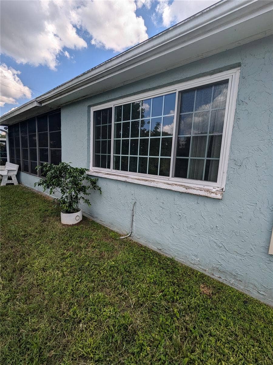 3937 SAIL DRIVE, New Port Richey, FL 34652 WINDOWS FROM EXTENDED LIVING AREA IN FOREGROUND AND SCREENED AND VINYL WINDOWED LANAI IN BACKGROUND