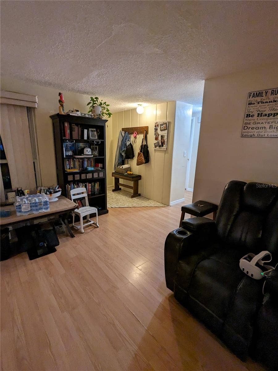 3937 SAIL DRIVE, New Port Richey, FL 34652 LIVING ROOM FOREGROUND AND FOYER IN BACKGROUND