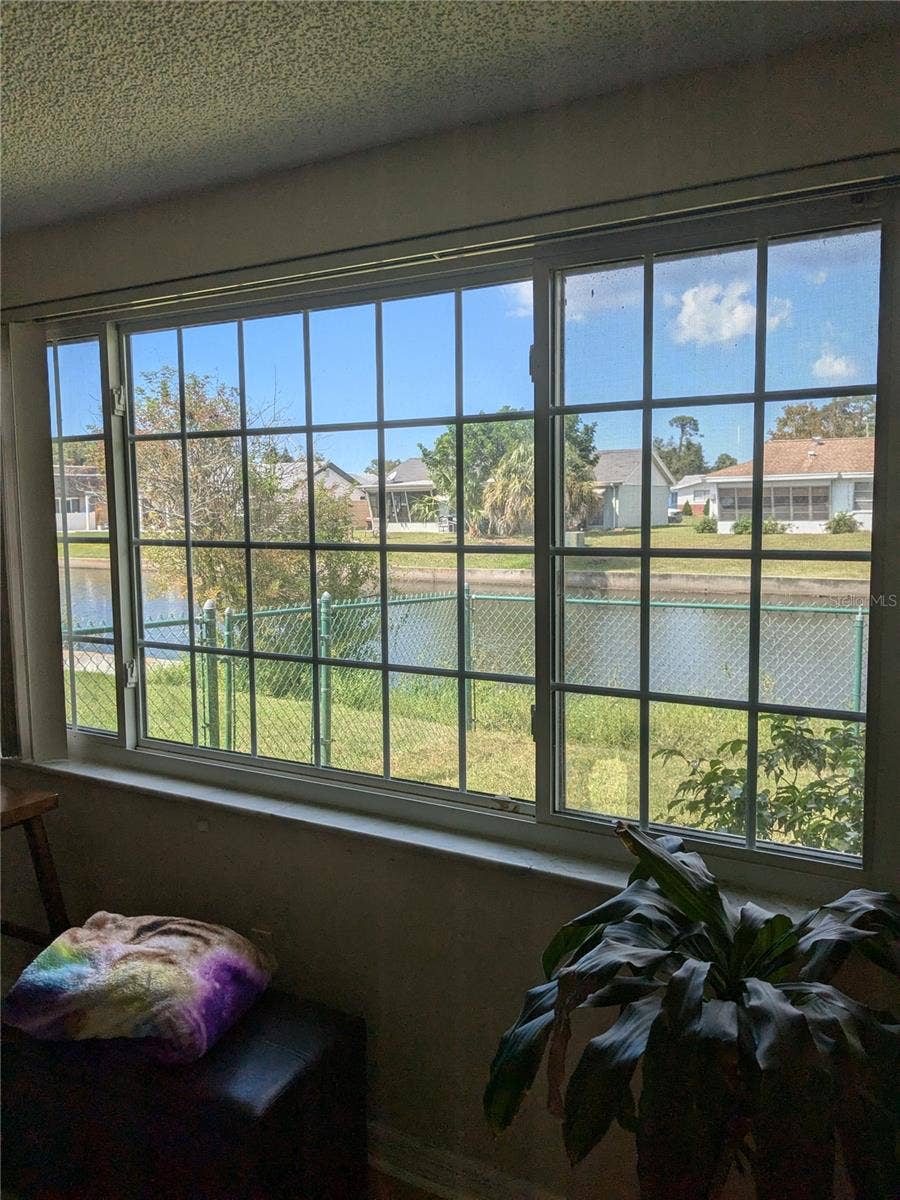 3937 SAIL DRIVE, New Port Richey, FL 34652 FABULOUS VIEW OF BACKYARD & FENCE WITH CANAL IN BACKGROUND