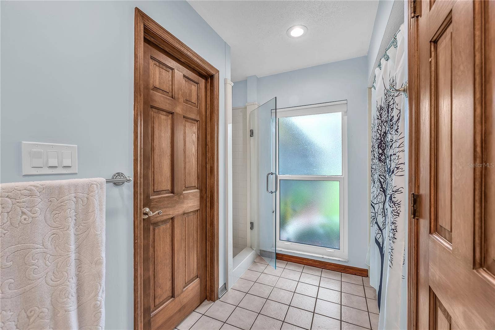 The primary bath features a separate shower, bath tub, private water closet, and linen closet for added comfort, privacy, and storage.