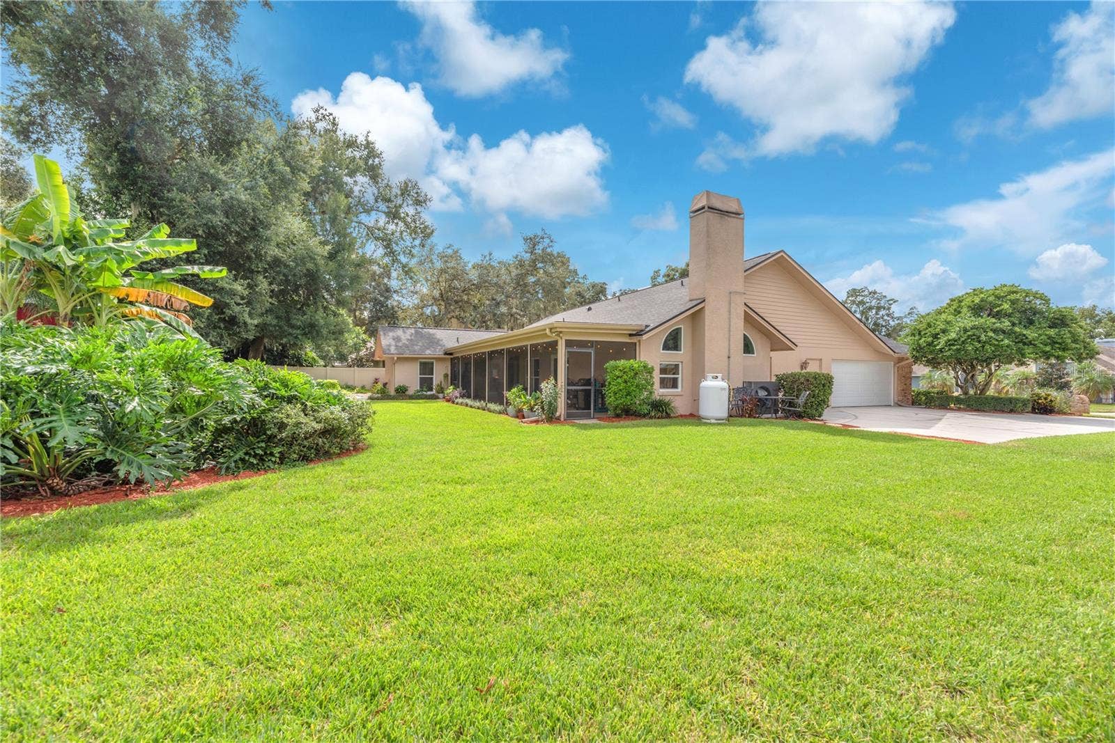 An expansive driveway provides ample off-street parking, while the oversized side-entry garage includes a dedicated workshop, offering plenty of space for projects, hobbies, and storage.  Propane tank for cooking is leased.