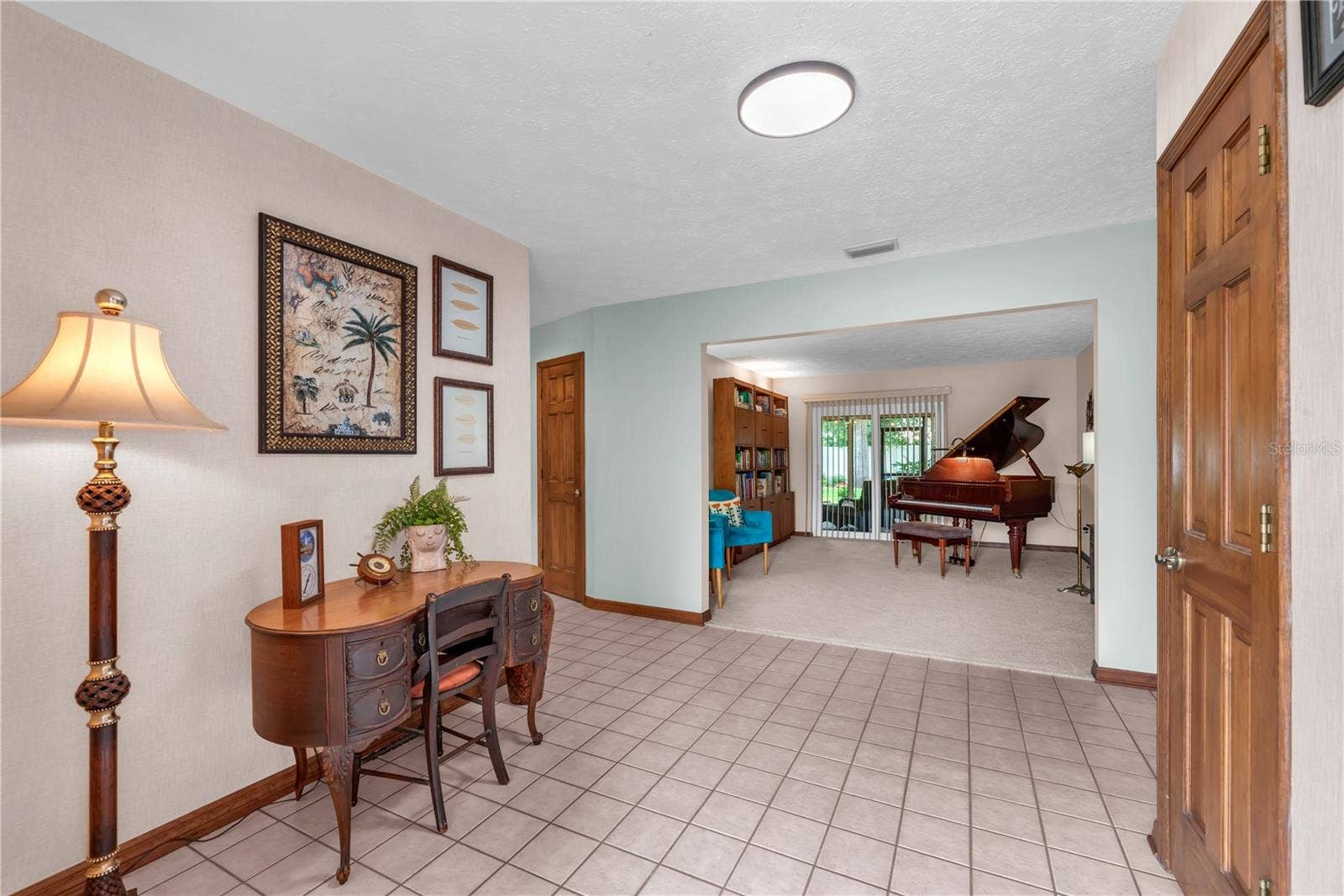 Step inside this foyer to discover beautiful wood trim, inviting living spaces, and a floor plan designed for both everyday comfort and elegant entertaining.