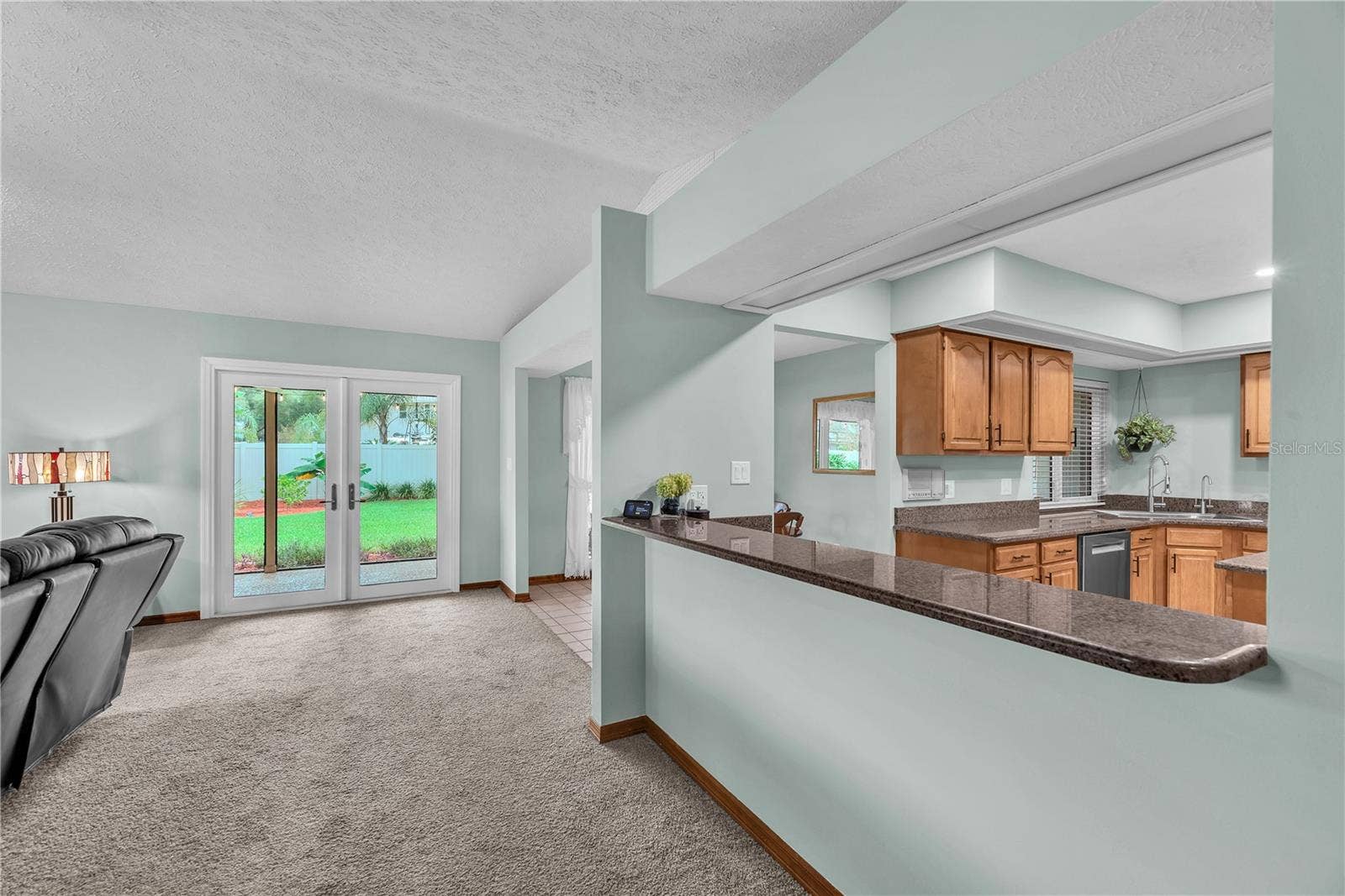 A spacious breakfast bar separates the kitchen from the family room, making it ideal for serving appetizers while entertaining family and friends.