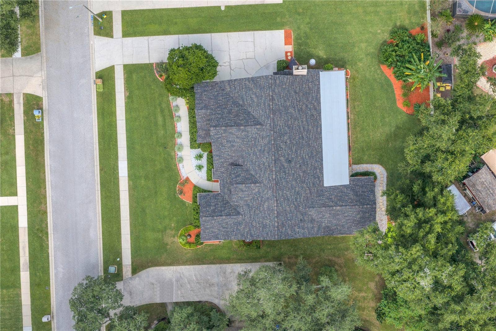 Recent improvements include an upgraded roof (2025), hurricane-rated windows, exterior doors, and garage door (2025) for added protection and peace of mind, the main HVAC system has been upgraded and air handler has been relocated out of the attic (2025), and two updated water heaters (2025). The kitchen features Bosch appliances, including a gas range (2023), along with updated lighting (2025). The septic system and drain field were replaced in 2020.