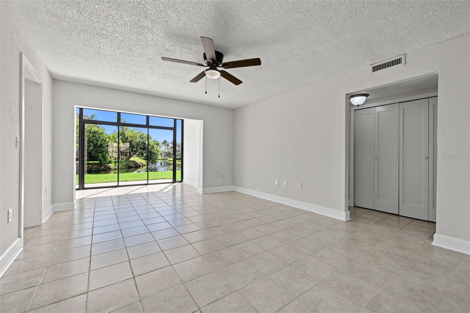 2460 HERON TERRACE, #102E, Clearwater, FL 33762 Living Room and Sunroom Angle