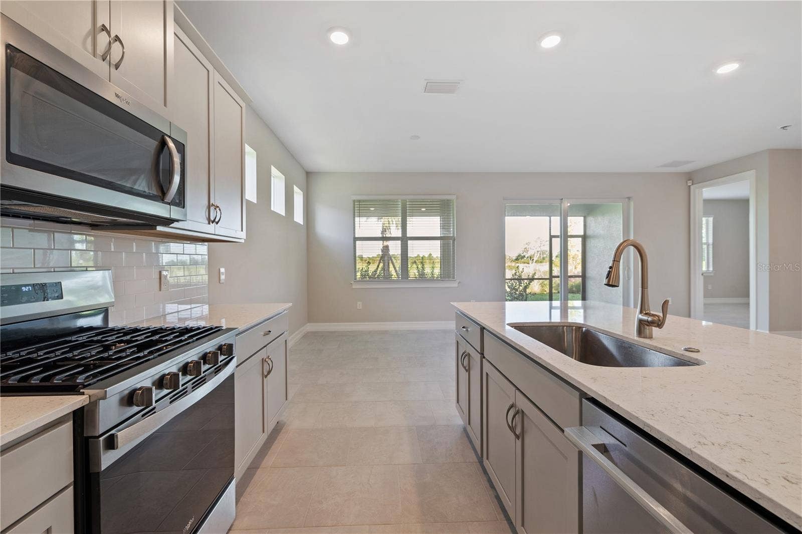 17740 SHADE TREE LOOP, Punta Gorda, FL 33982 Kitchen Island with dishwasher and sink.
