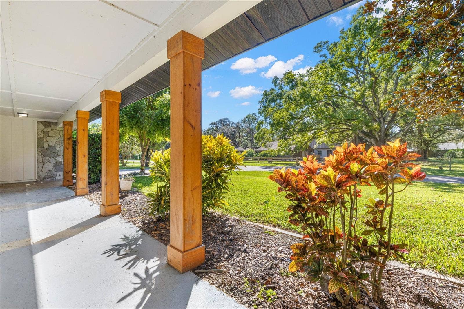 3013 GRAHAM LANE, Tampa, FL 33618 The expansive covered front porch offers a shaded spot to relax, enjoy your morning coffee, or unwind while overlooking the beautifully landscaped front lawn and mature shade trees.