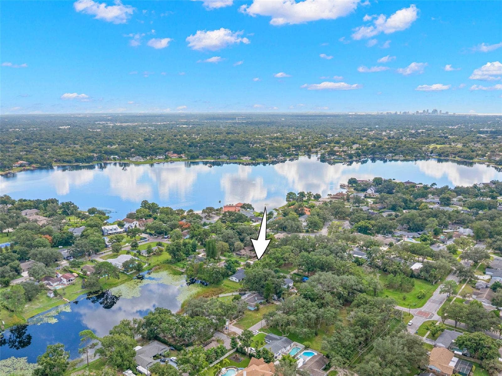 3013 GRAHAM LANE, Tampa, FL 33618 Discover the charm of Carrollwood from above! This aerial perspective highlights the property's location in an established, tree-lined neighborhood, surrounded by scenic lakes and residential streets, with convenient access to North Dale Mabry Highway and the greater Tampa area.