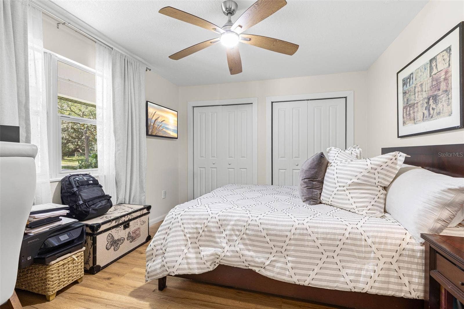 3013 GRAHAM LANE, Tampa, FL 33618 Bedroom four features two closets for ample storage, wood-look luxury vinyl flooring, a modern ceiling fan, and a window overlooking the front yard. A versatile room equally suited for guests, a home office, or a personal retreat.