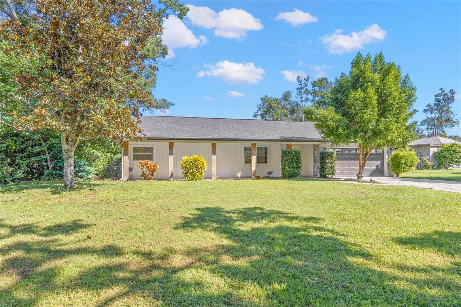 3013 GRAHAM LANE, Tampa, FL 33618 Set on a spacious .34-acre lot, this attractive single-story home features a sweeping front lawn, mature shade trees, established landscaping, and a welcoming covered front porch.