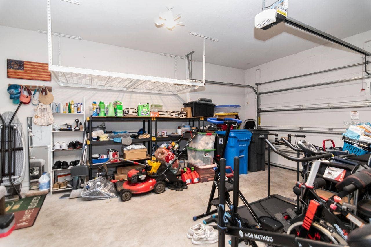 11143 SPRING POINT CIRCLE, Riverview, FL 33579 Enclosed Garage with 2 hanging storage racks