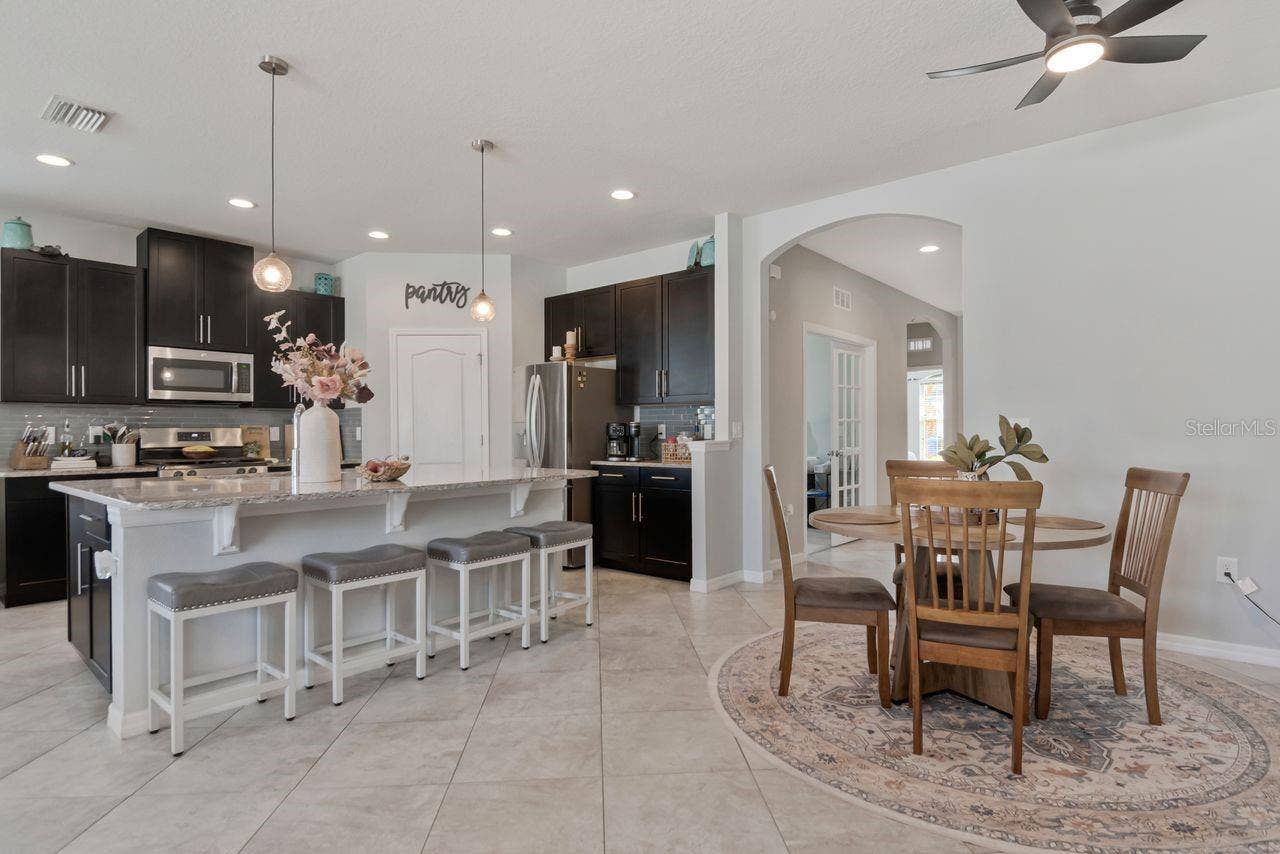 11143 SPRING POINT CIRCLE, Riverview, FL 33579 Open concept kitchen with plenty of counter seating availability, large countertop perfect for entertaining.