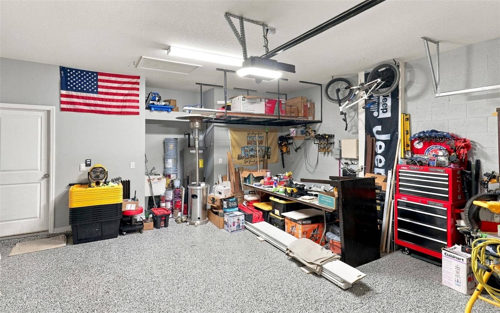 33310 MAJOR OAK DRIVE, Wesley Chapel, FL 33545 Garage Showcasing Epoxy-Coated Flooring and Ample Storage Space