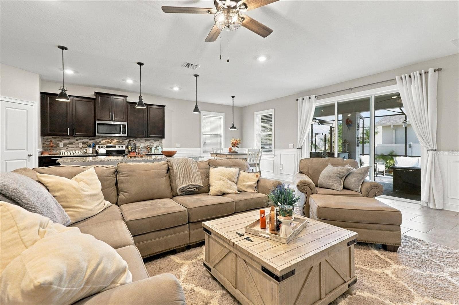 33310 MAJOR OAK DRIVE, Wesley Chapel, FL 33545 Living Area Flowing Seamlessly into Kitchen and Dining Spaces