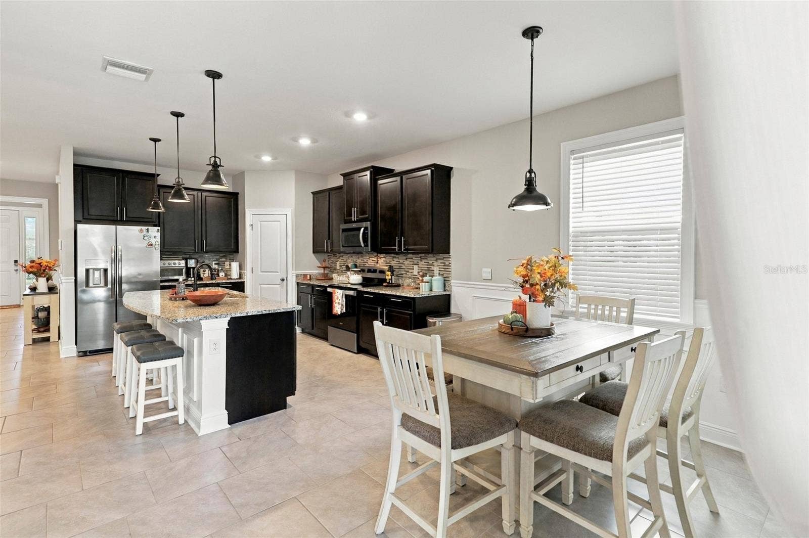 33310 MAJOR OAK DRIVE, Wesley Chapel, FL 33545 Open-Concept Kitchen and Dining Area with Pendant Lighting