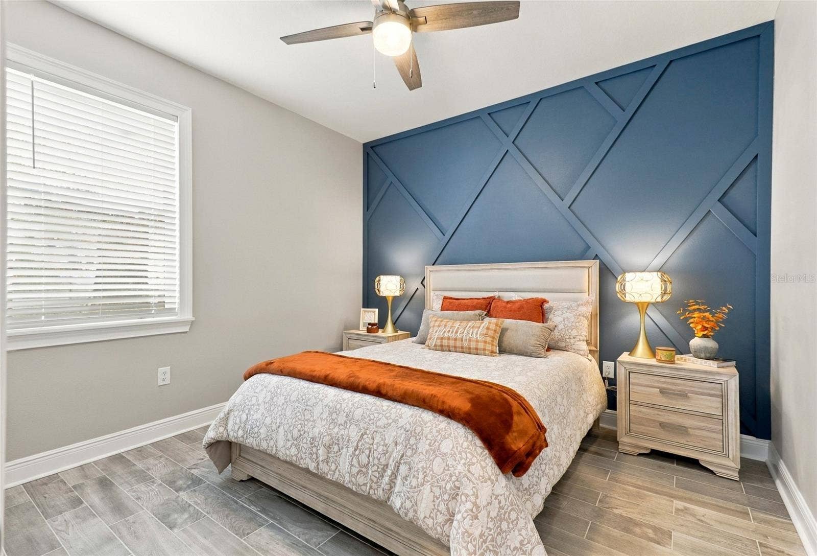 33310 MAJOR OAK DRIVE, Wesley Chapel, FL 33545 Bedroom Featuring a Decorative Blue Accent Wall and Tile Flooring