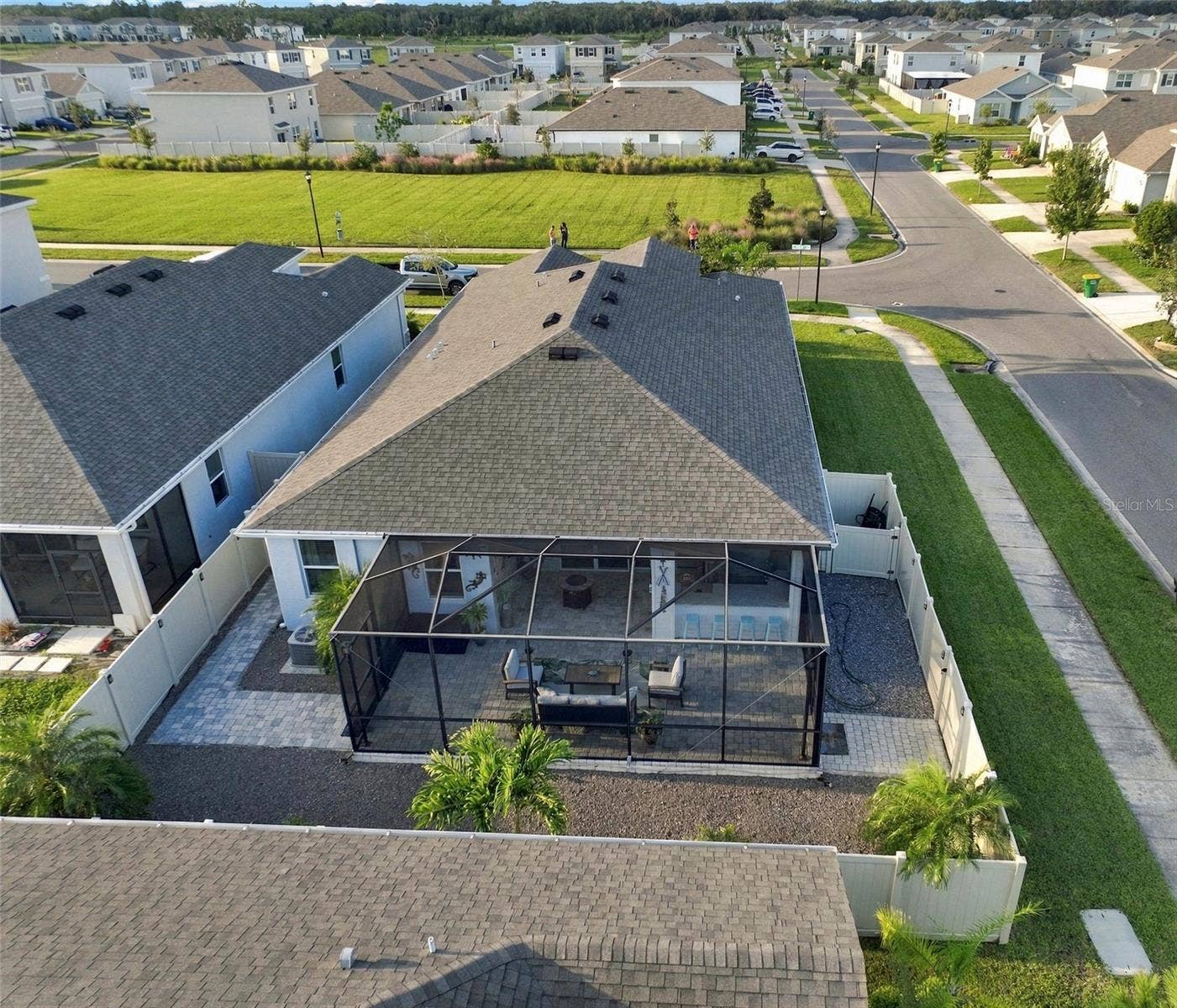 33310 MAJOR OAK DRIVE, Wesley Chapel, FL 33545 Rear View Showcasing the Home's Roofline and Outdoor Living Area