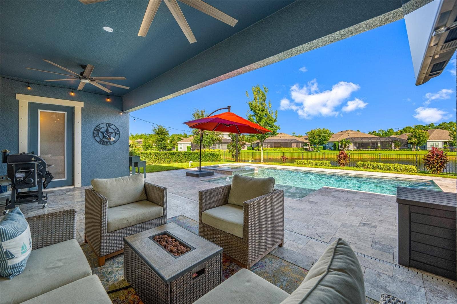 4161 GLADE WOOD LOOP, New Port Richey, FL 34655 Lanai with pool and spa overlooking fenced backyard on a pond