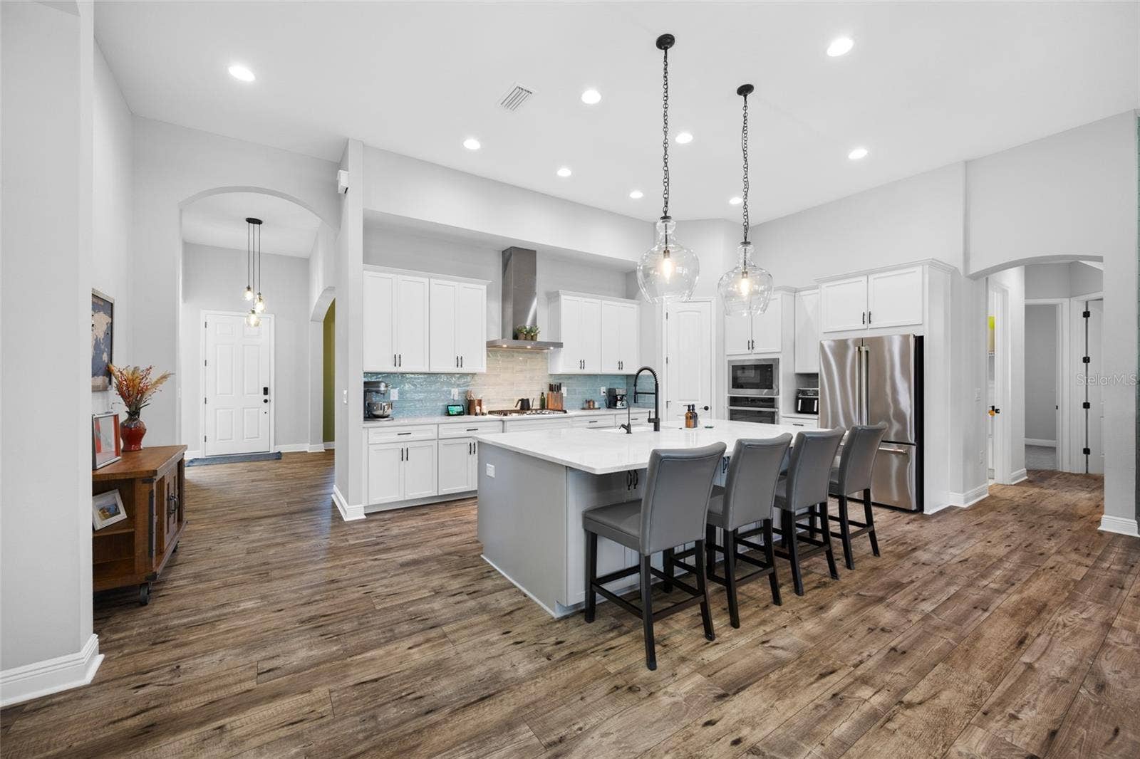 4161 GLADE WOOD LOOP, New Port Richey, FL 34655 Kitchen with GE Cafe & Profile appliances Gas cooktop & wall oven and 9 foot quartz island
