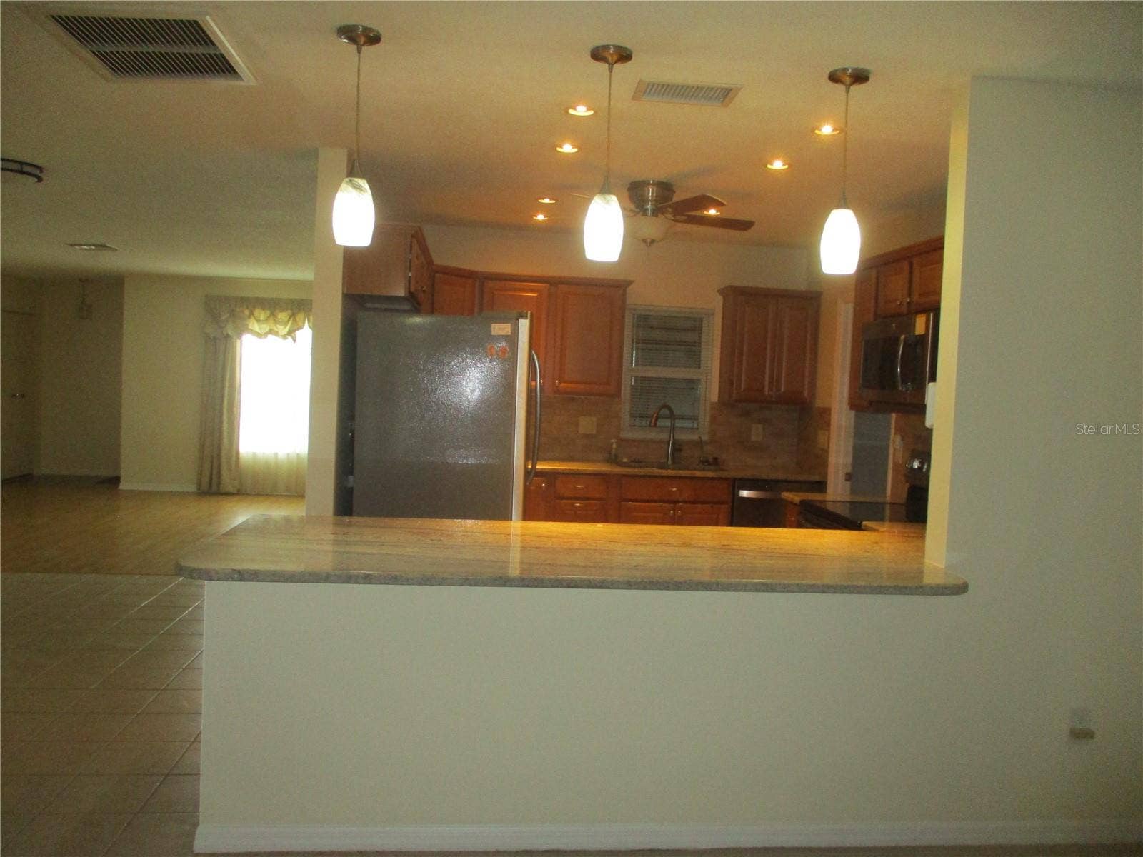 1703 CLOISTER DRIVE, Sun City Center, FL 33573 kitchen pass through from family room