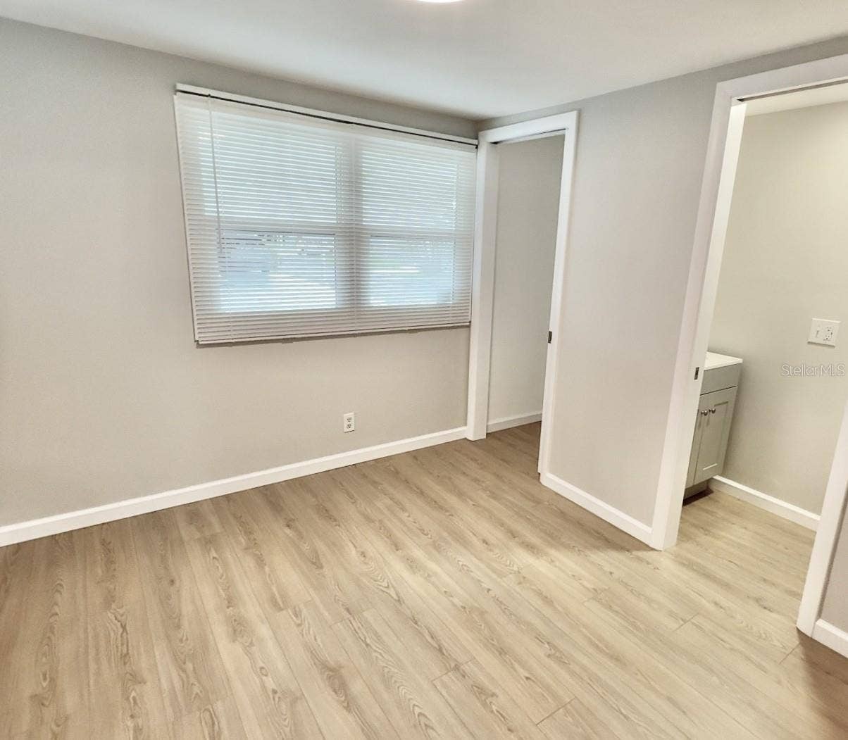 7173 MOUNT BRISTOL BOULEVARD NE, #458, St Petersburg, FL 33702 guest bedroom with ensuite half bath