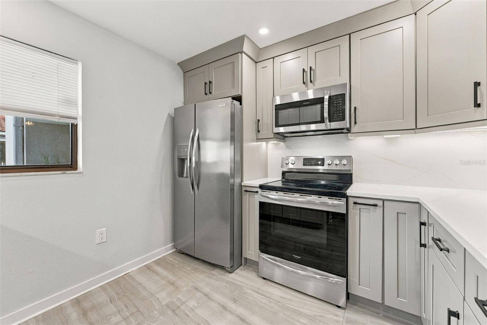 Updated kitchen with shaker-style cabinetry and new appliances
