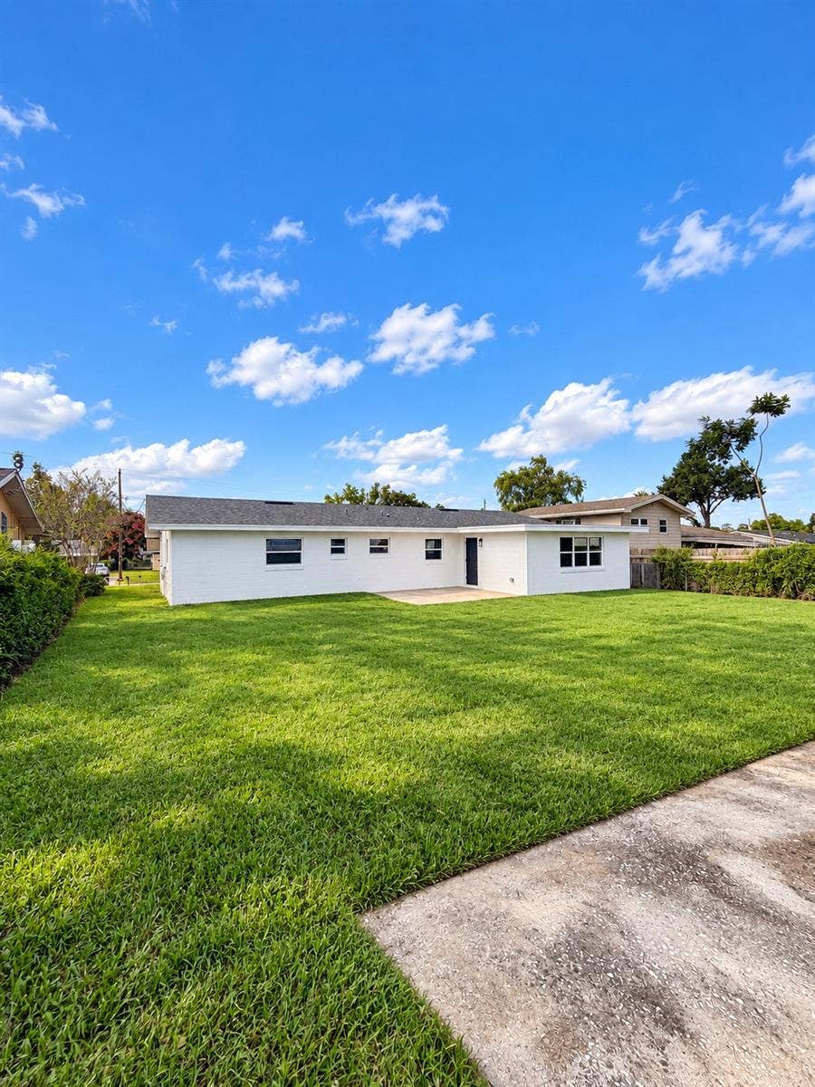 120 HAWTHORNE ROAD, Winter Haven, FL 33884 Spacious backyard offering an open lawn and room for outdoor activities.