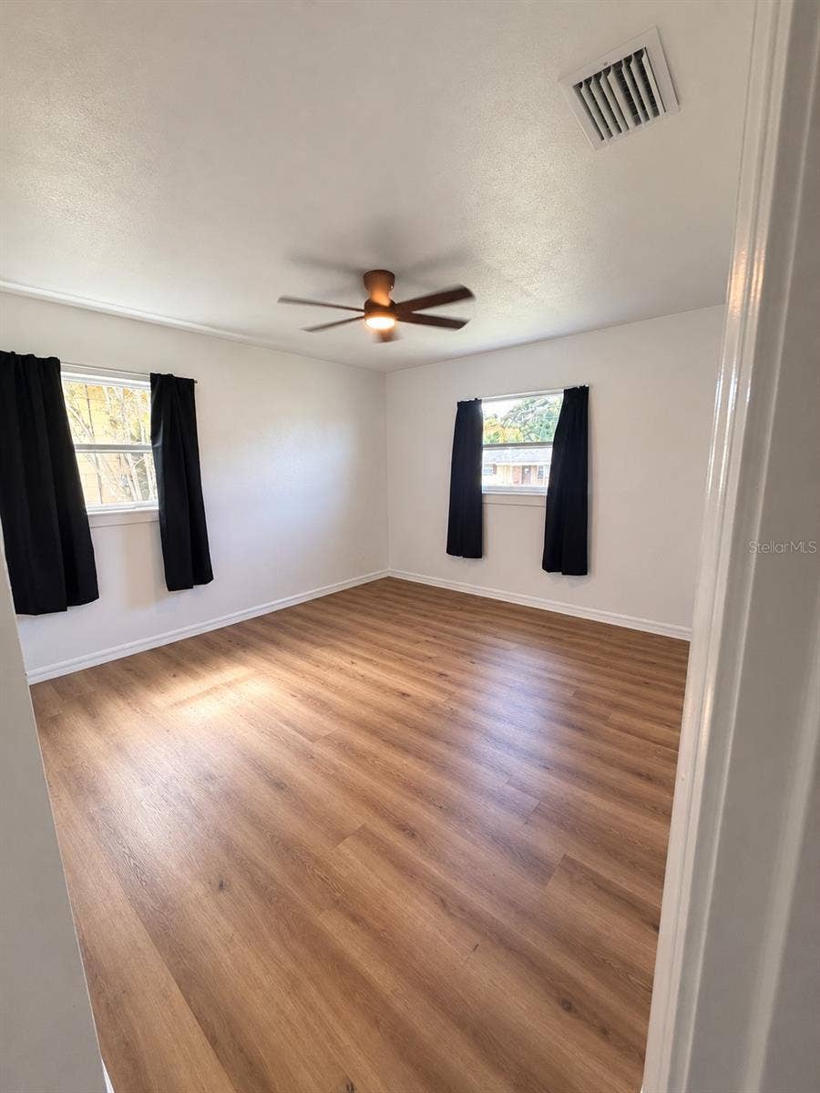 120 HAWTHORNE ROAD, Winter Haven, FL 33884 Flexible bedroom space with wood-look flooring, neutral finishes, and natural light and built in closet