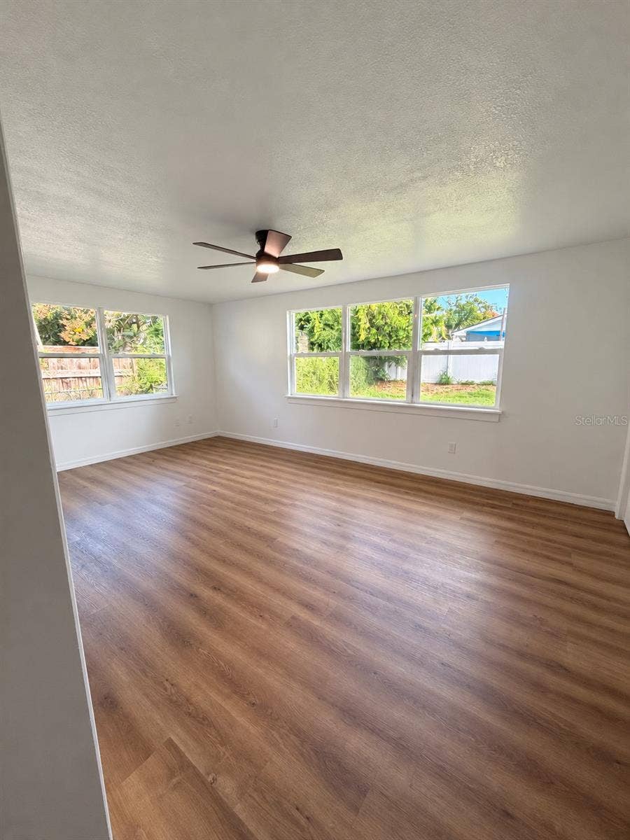 120 HAWTHORNE ROAD, Winter Haven, FL 33884 Spacious dining area with or bonus room with wood-look flooring and large windows overlooking the backyard.