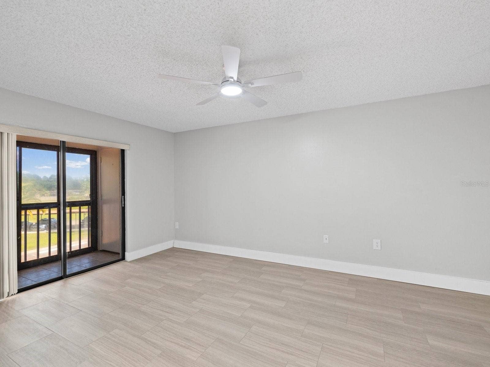 Primary bedroom with private screen patio and storage closet