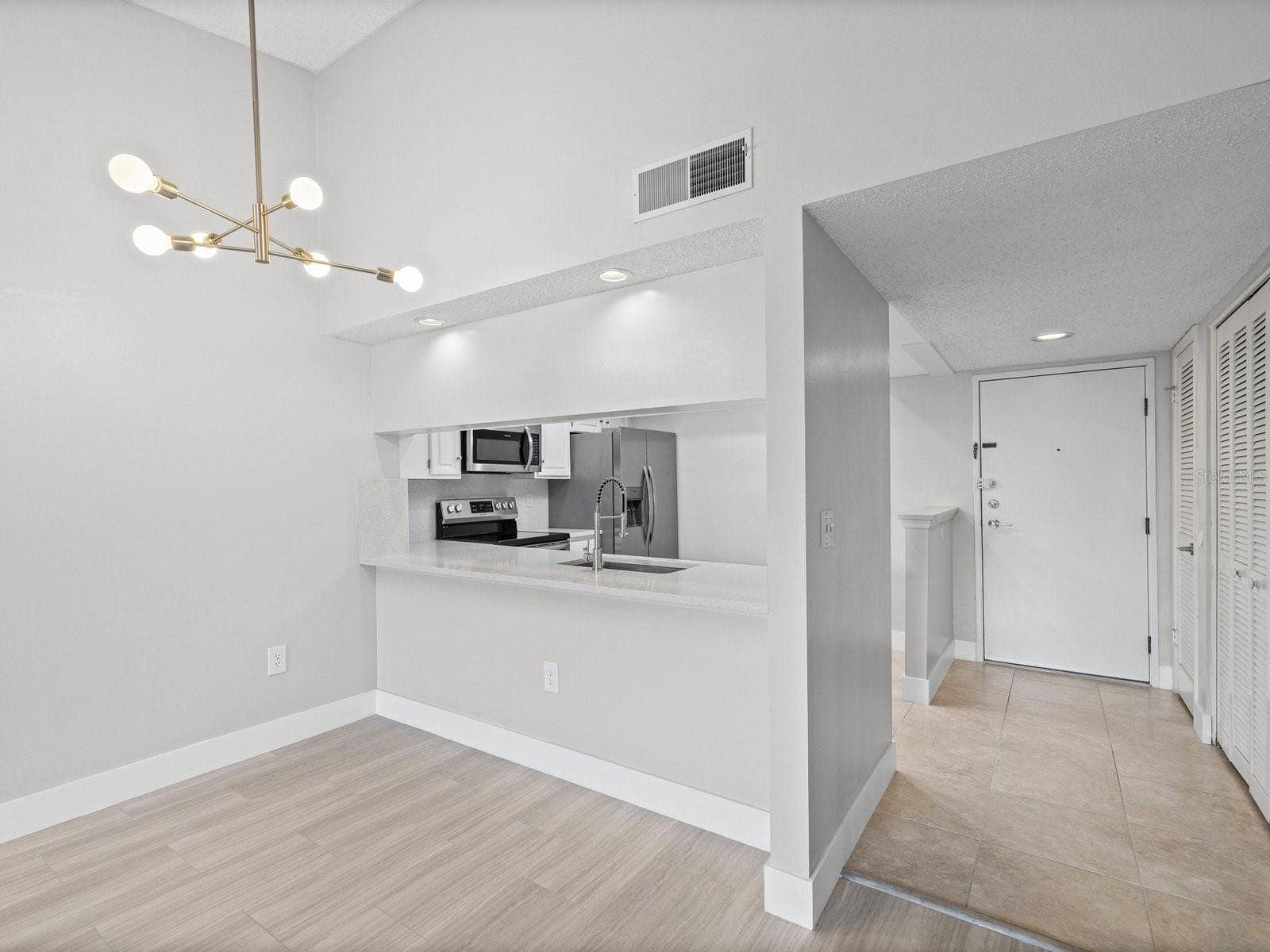 Vault ceiling and new modern light fixture in dining room