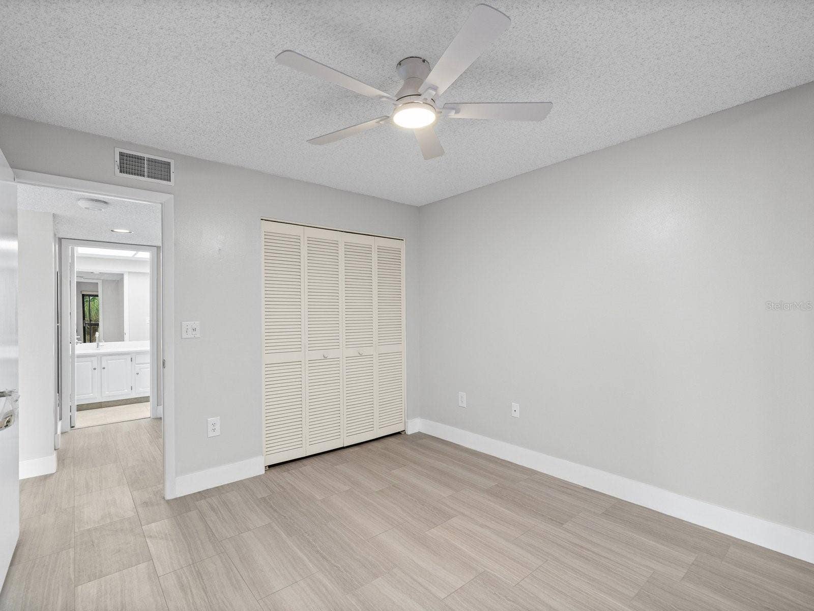 Guest bedroom with hall to guest bath and laundry room