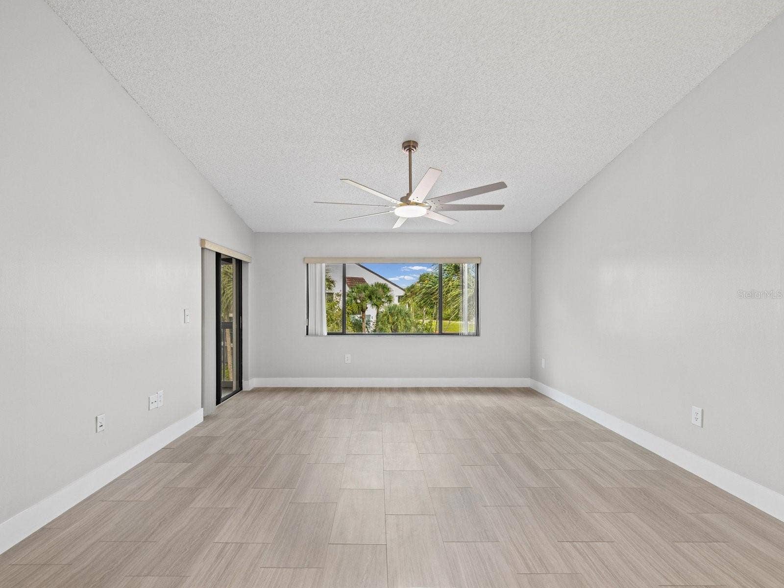 Living room views of palms and screen porch entry on left