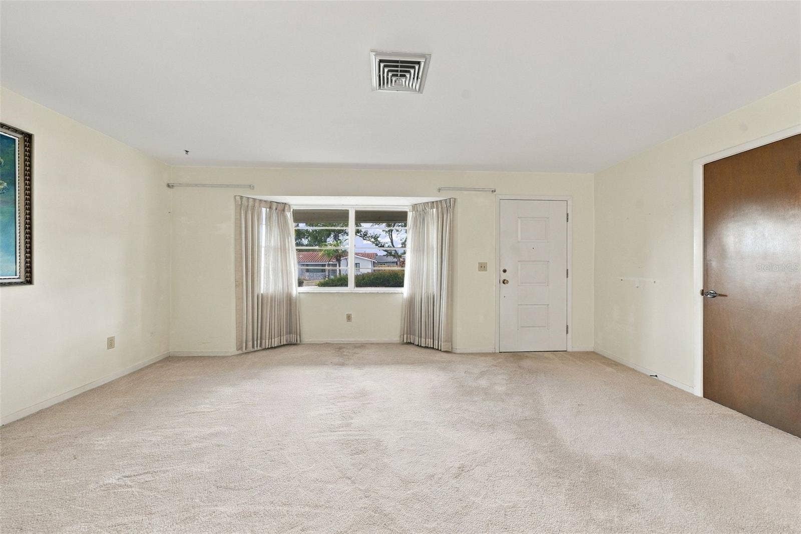 12266 69TH TERRACE, Seminole, FL 33772 Alternate view of living room featuring large windows, lots of natural light