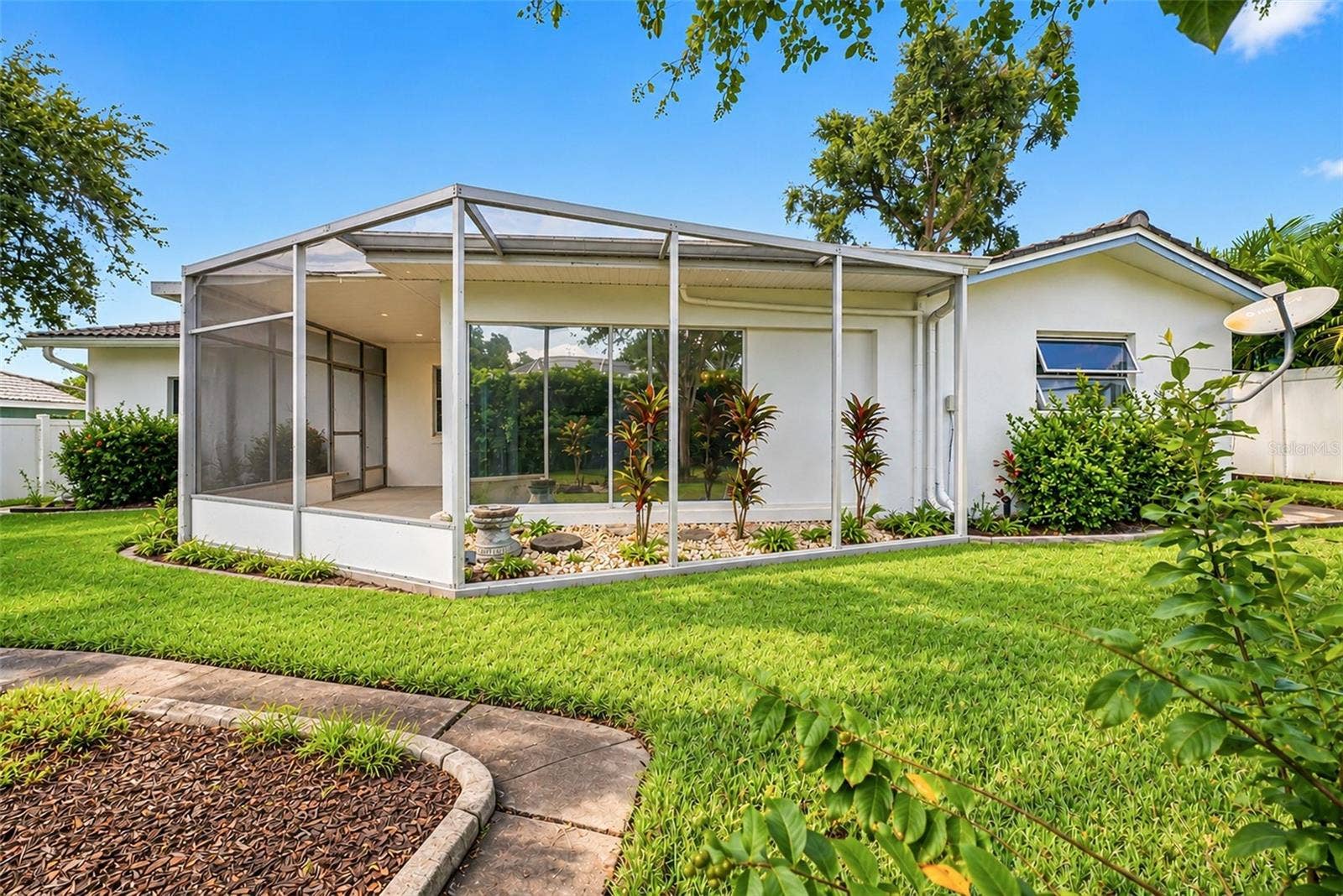 12266 69TH TERRACE, Seminole, FL 33772 Backyard view featuring the screened in porch