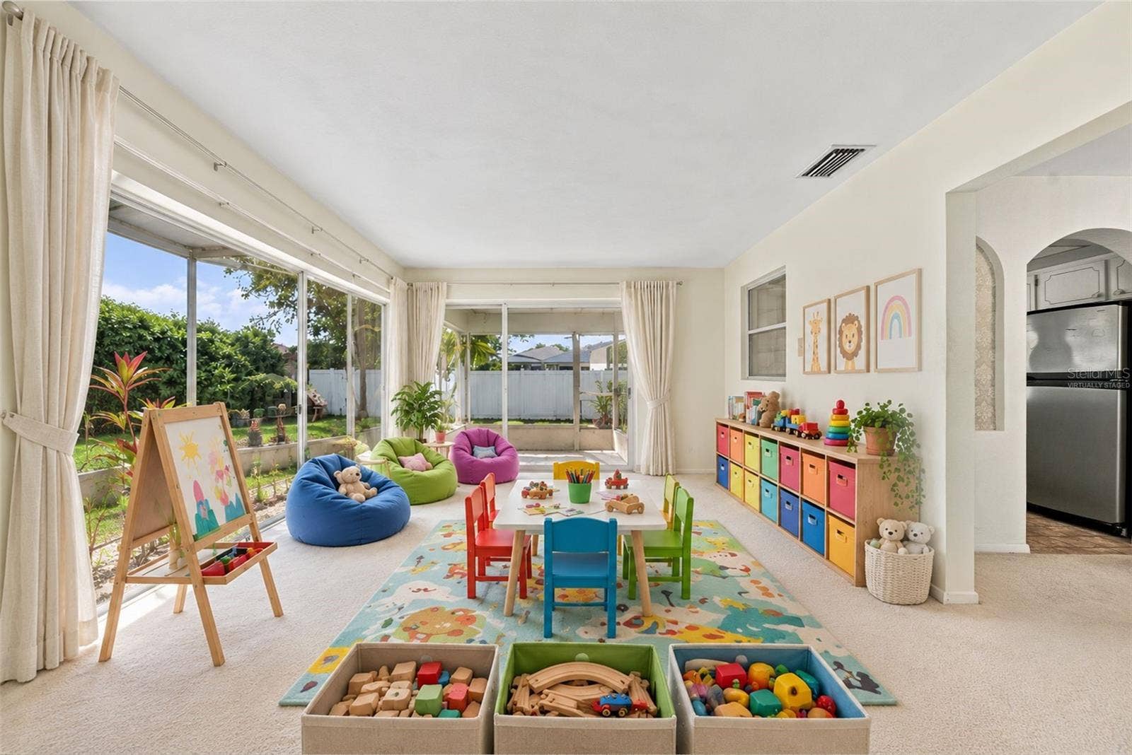 12266 69TH TERRACE, Seminole, FL 33772 Virtually Staged, can be turned into a playroom with lots of natural light from the sliding glass doors showcasing versatile space