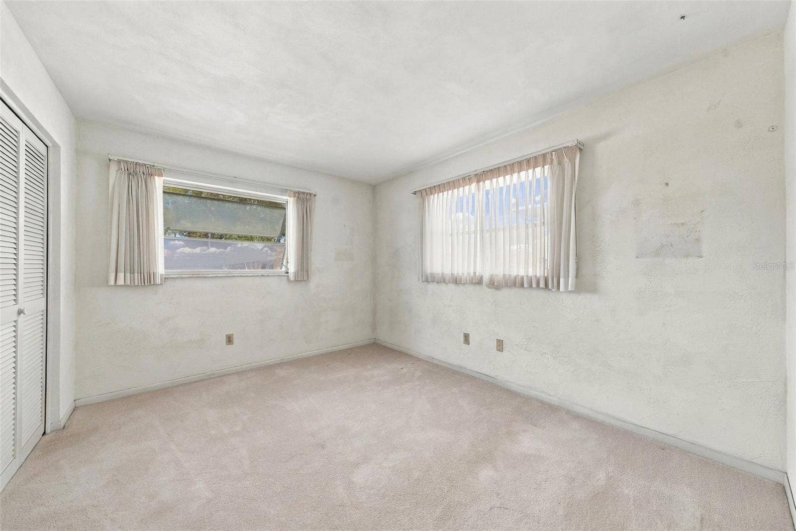 12266 69TH TERRACE, Seminole, FL 33772 Large windows featuring ample natural light in primary bedroom