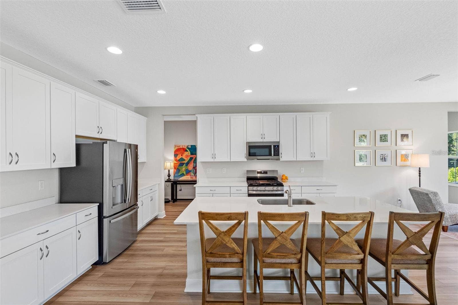 14868 SUMMER BRANCH DRIVE, Lithia, FL 33547 Kitchen with quartz countertops, a seating island, and a gas range