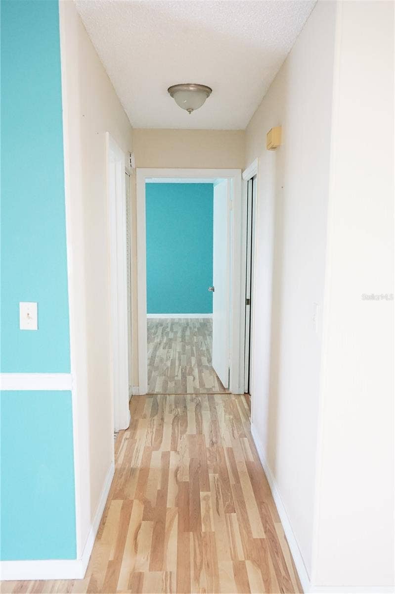703 HUXLEY PLACE, Sun City Center, FL 33573 hallway to bedrooms