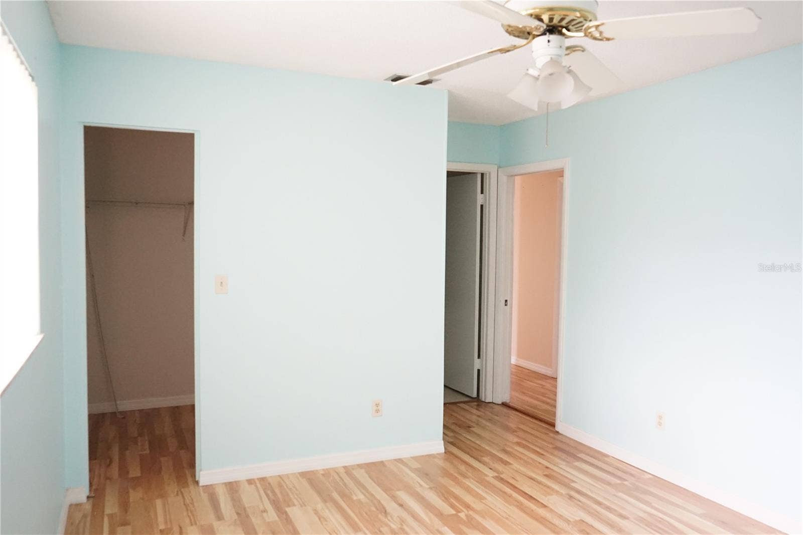 703 HUXLEY PLACE, Sun City Center, FL 33573 primary bedroom and walk in closet to the left