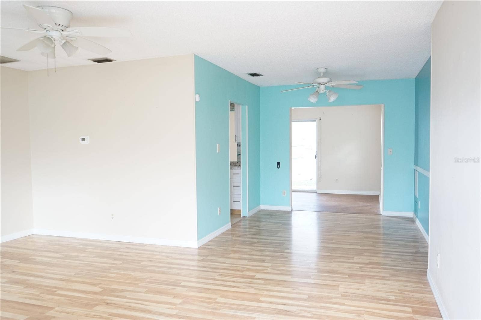703 HUXLEY PLACE, Sun City Center, FL 33573 living room and blue dining area