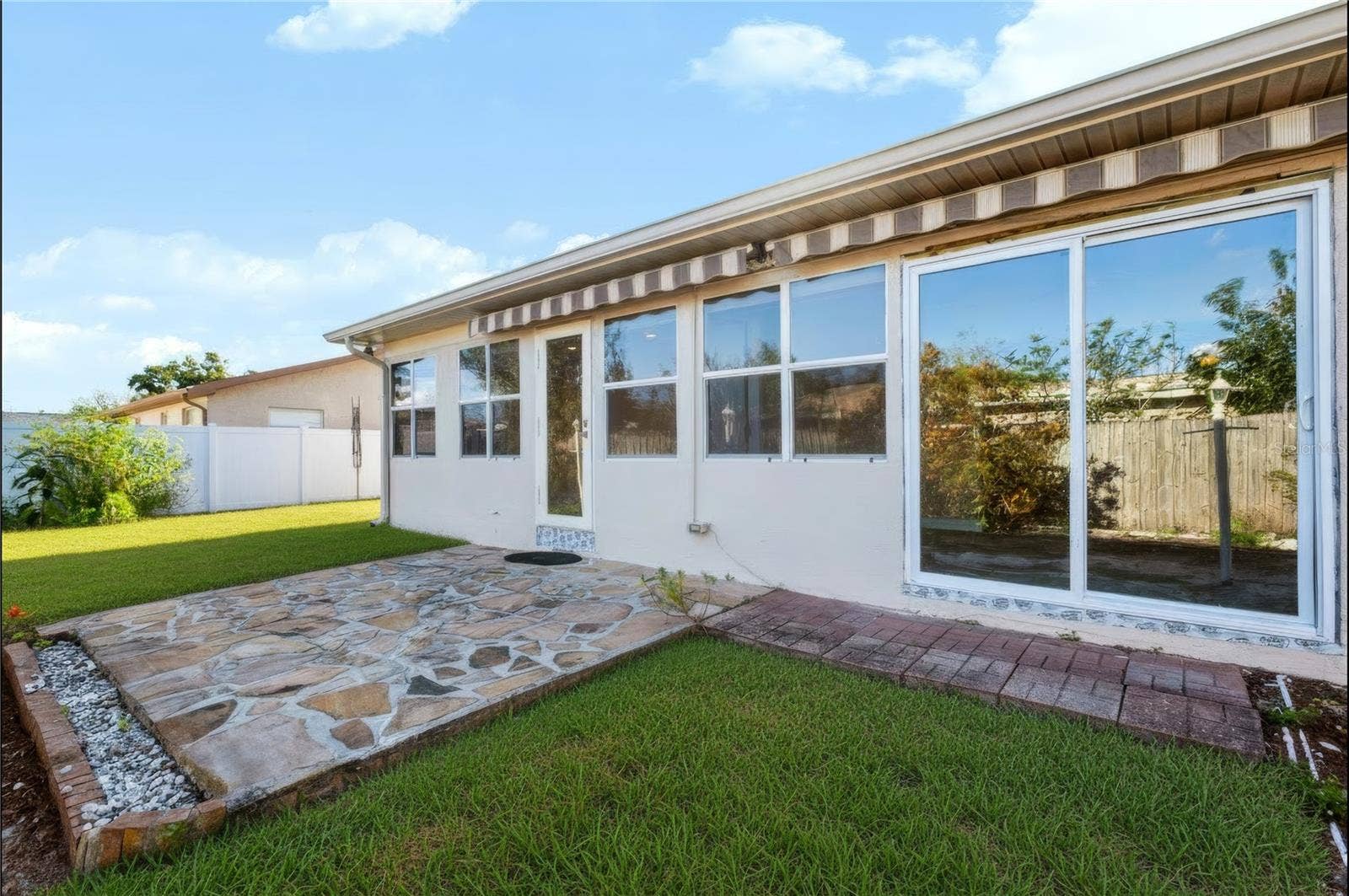 12939 115TH STREET, Largo, FL 33778 Patio space off of the Florida room in the back yard